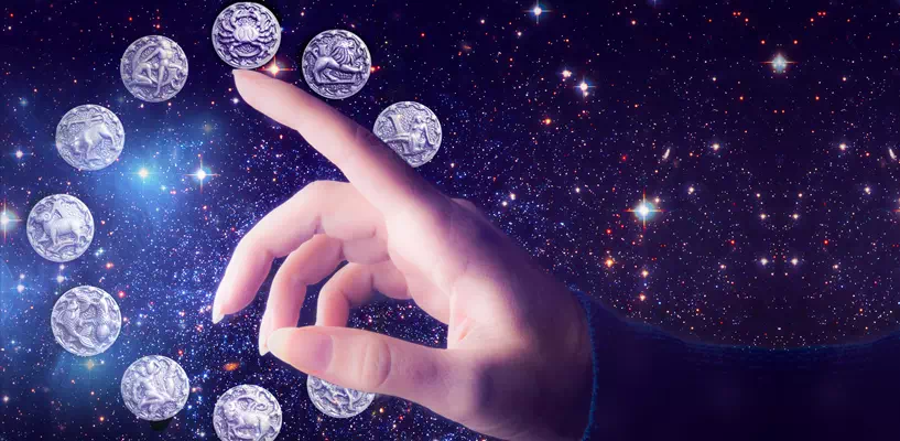 A hand, galaxy and the zodiac signs
